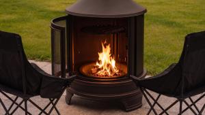 a fire pit with two chairs next to it at Yeongheungdo Stay Noc Pool Villa in Incheon +4 photos