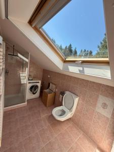 a bathroom with a toilet and a window in it at Elegant house in a dominant position in Tour de Treme