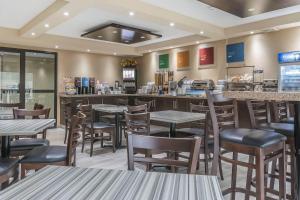 a restaurant with tables and chairs and a bar at Comfort Inn Trenton in Trenton