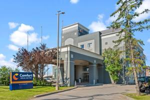 a building with a sign in front of it at Comfort Inn & Suites Airport South in Calgary