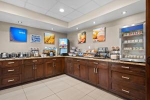a store with wooden cabinets and a food counter at Comfort Inn & Suites Airport South in Calgary