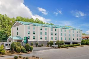 a large white building with a blue roof at Quality Inn & Suites Union City - Atlanta South in Union City