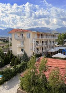 a large apartment building with mountains in the background at Intour in Cholpon-Ata