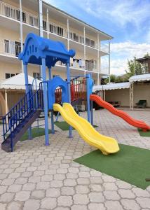 a playground with slides in front of a building at Intour in Cholpon-Ata
