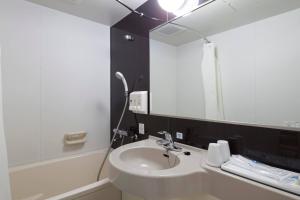 a bathroom with a sink and a mirror at Comfort Hotel Tsubamesanjo in Sanjo +19 photos