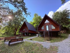 a cabin with a bench in front of it at Glola A-Frame Cottages in Glola
