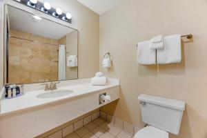 a bathroom with a sink and a toilet and a mirror at Newport Oceanfront Inn in Newport +13 photos
