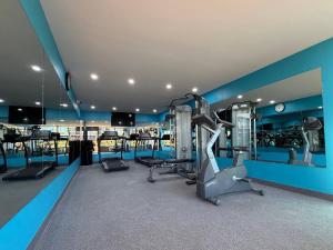a gym with several treadmills and machines in a room at Clarion Inn in Greenville