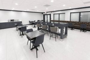 a dining room with tables and chairs in a building at Clarion Inn in Greenville +18 photos
