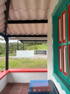 a room with a window with a view of a field at Masinga FarmHouse in Filandia