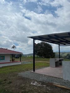 a pavilion in front of a house with a building at Masinga FarmHouse in Filandia