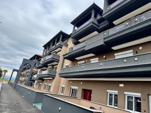 a building with balconies on the side of it at Milaluxe in Paralia Katerinis