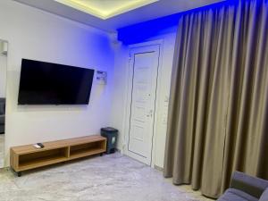 a living room with a flat screen tv on a wall at Milaluxe in Paralia Katerinis +11 photos