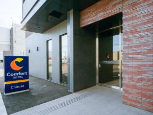 a building with a sign in front of a building at Comfort Hotel Chitose in Chitose