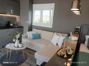 a living room with a couch and a table at VueSurMer Amarynthos in Amarynthos