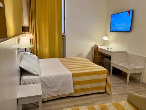 a hotel room with a bed and a desk at Camere LAURO ROSSI in Macerata +8 photos