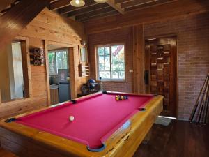 a pool table in a living room with avertisementatronatronatronstrationstrationstration at Sangria Pinesview Chalet in Baguio