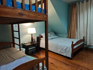a bedroom with two bunk beds and a ladder at Sangria Pinesview Chalet in Baguio +42 photos