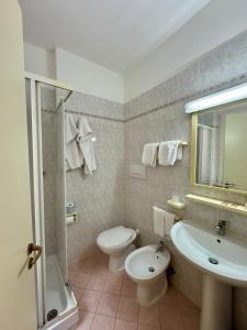 a bathroom with a toilet and a sink and a shower at Camere LAURO ROSSI in Macerata