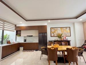 a kitchen and dining room with a table and chairs at Su House Villa in Gò Ba Quần