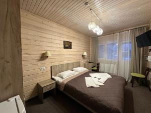 a bedroom with a bed in a wooden room at Шале На бе́резі in Kvasy