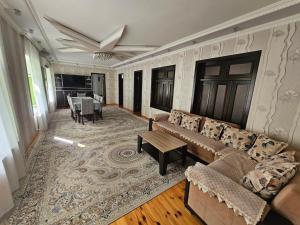 a living room with a couch and a table at Green Garden RHB in Gabala