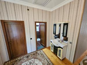 a bathroom with a sink and a mirror at Green Garden RHB in Gabala