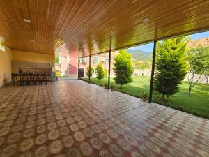 a large room with a large wooden ceiling at Green Garden RHB in Gabala +14 photos