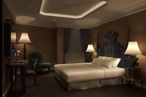 a bedroom with a bed and a table and chairs at Hôtel Le Joyau Bleu Hanoï in Hanoi +87 photos
