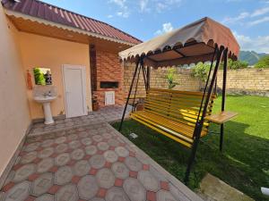 a bench in a gazebo in a yard at Green Garden RHB in Gabala