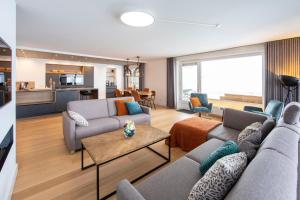 a living room with a couch and a table at Ferienwohnung Penthouse Feldberg in Feldberg