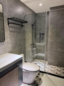 a bathroom with a toilet and a shower at Long Lang Homestay in Tainan