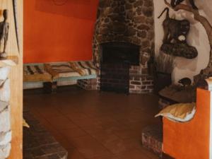 a room with a stone fireplace with beds in it at Klipspringer Lodge in Nelspruit +15 photos