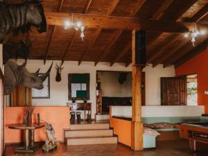 a room with a bed and a room with a table at Klipspringer Lodge in Nelspruit