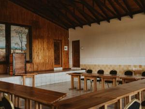 an empty classroom with wooden tables and chairs at Klipspringer Lodge in Nelspruit