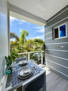 a table with plates and glasses on a balcony at Sapphire Boutique Resort in Panglao Island