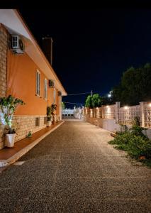 an empty street next to a house at night at Villa Daisy Conversano-Polignano a Mare in Conversano