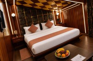 a bedroom with a bed with a bowl of fruit on a table at Pine view in Gulmarg
