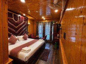 a bedroom with a bed in a wooden room at Pine view in Gulmarg