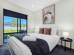 a bedroom with a large bed and a large window at Wrenwood in Abernethy +11 photos