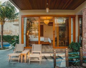 a patio with two chairs and a bed in a bedroom at MJ Villa Sanur in Sanur +61 photos