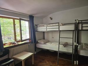 a room with two bunk beds and a table at HOSTEL SPORT BUCHAREST in Bucharest