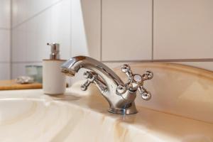 a kitchen sink with a faucet on a counter at Cattle Barn - leben auf dem Hof in Tröndel +18 photos