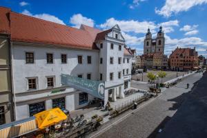 a city street with buildings and a street sign at Boutique Hotel Schwarzer Baer in Lutherstadt Wittenberg