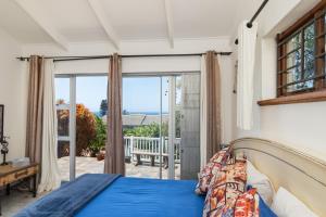 a bedroom with a bed and a large window at Blue Nautica Coastal Retreat in Ballito +22 photos