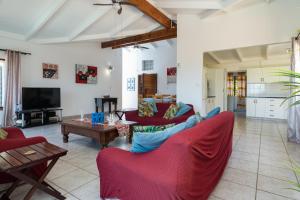 a living room with two couches and a tv at Blue Nautica Coastal Retreat in Ballito