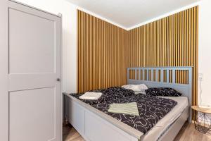 a bedroom with a bed with a yellow striped wall at Apartment Maja in Winterberg