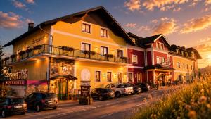 a building with cars parked in front of it on a street at Mohnhotel - Bergwirt Schrammel in Zwettl Stadt