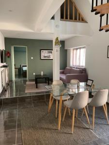 a living room with a glass table and chairs at Maison Wintzenheim in Wintzenheim