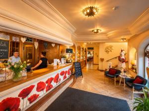 a restaurant with a counter with red poppies at Mohnhotel - Bergwirt Schrammel in Zwettl Stadt